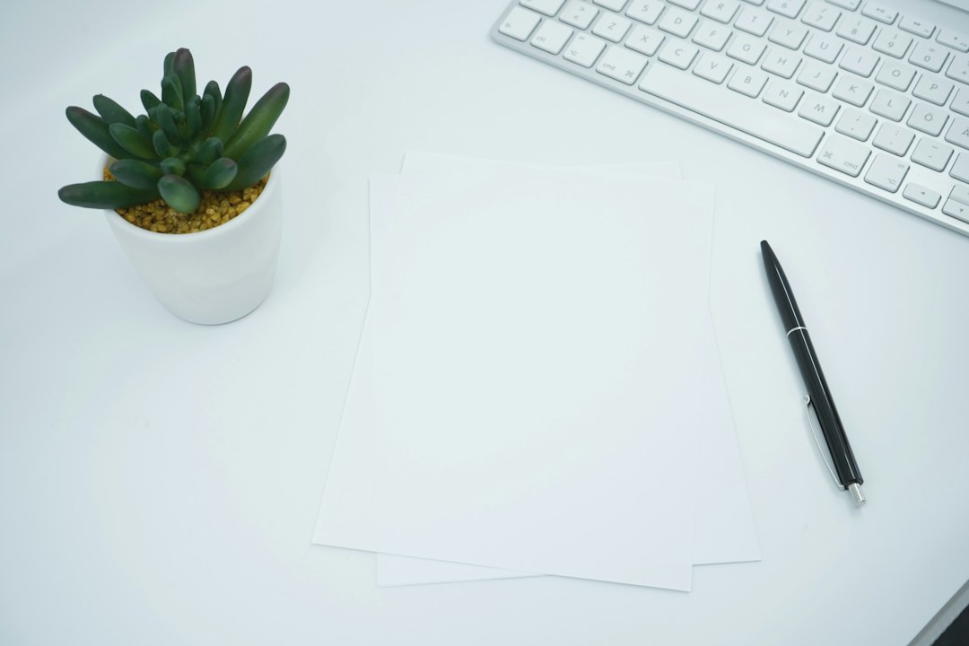 Professional office desk with documents, keyboard and stationery